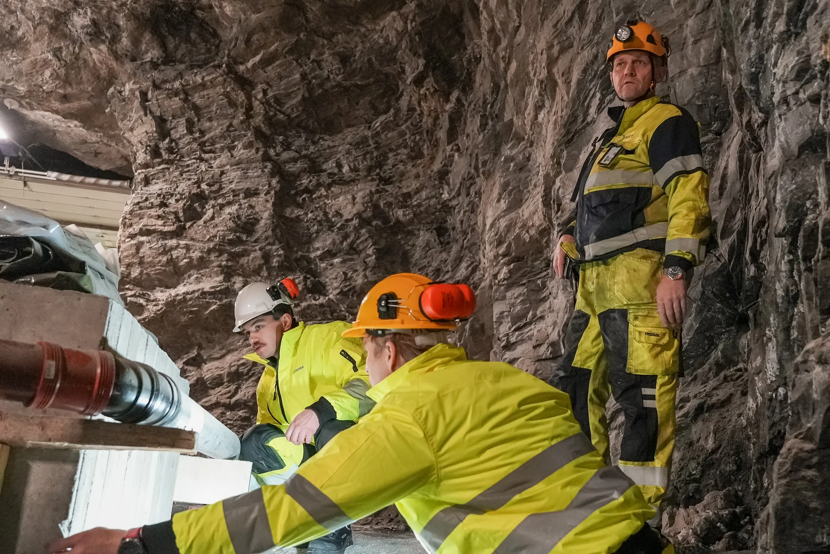 Liam Nolan (white helmet) with colleagues inspecting a cut in a rock tunnel